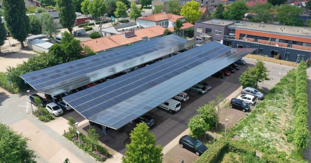 an overhead view of a parking lot with solar panels.