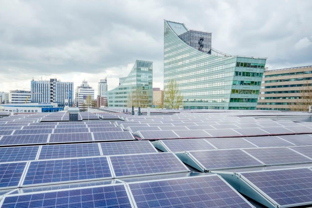 a row of solar panels in a city.