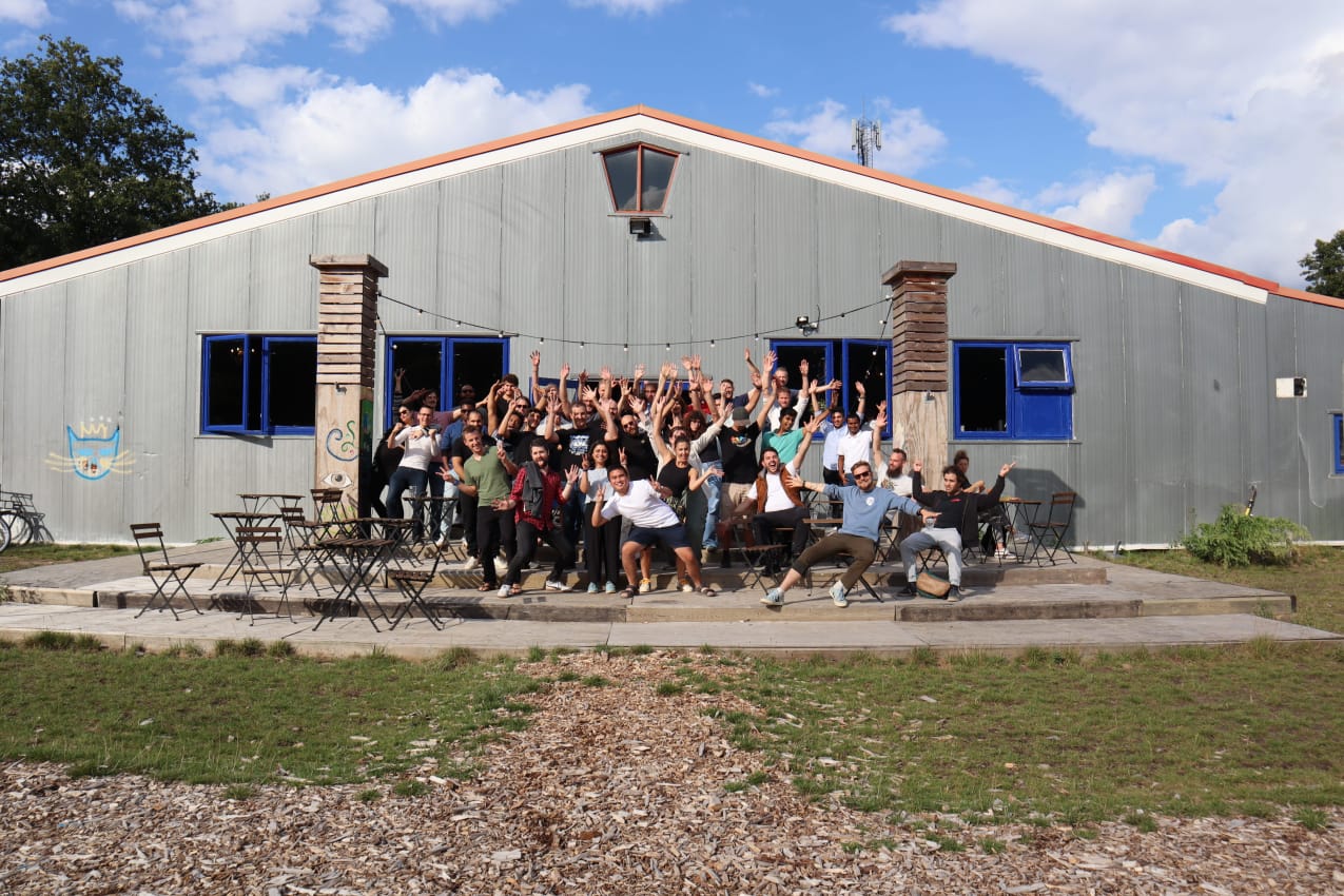 a group of people standing in front of a building.