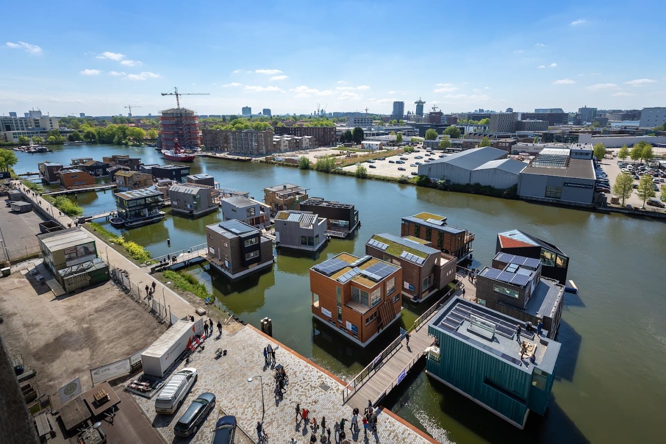 an aerial view of a canal with many boats.